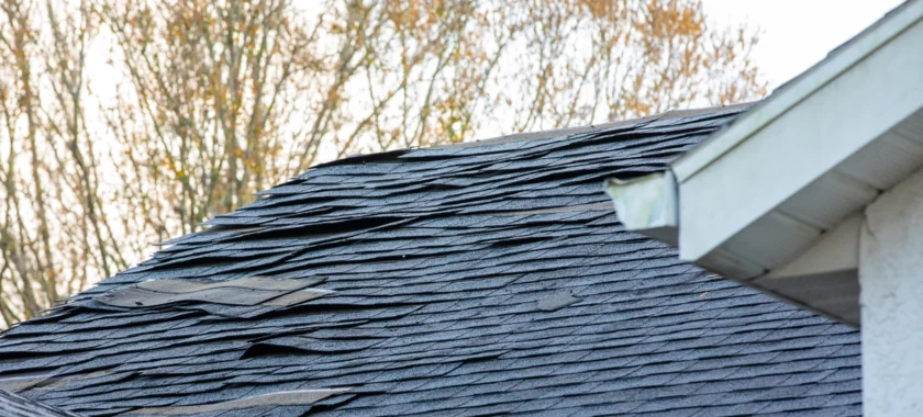 Curled asphalt roof shingles showing signs of aging and damage on a residential roof in Vancouver